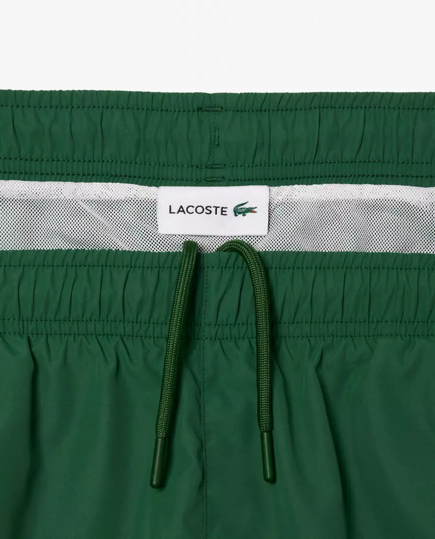 LACOSTE Зелені плавки з написом